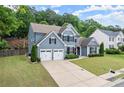 Stylish two-story home with lush lawn, attached two-car garage and inviting curb appeal at 214 Crestmont Way, Canton, GA 30114