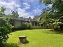 A lush green backyard featuring a well and ample space for outdoor activities at 4380 Highway 138, Oxford, GA 30054