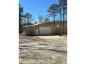 Large outbuilding for parking and projects with some play equipment off to the side at 1016 Green Dr, Canton, GA 30114