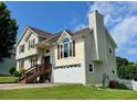 Two-story house featuring a two-car garage, a chimney and a staircase leading up to the front door at 19 Magnolia Ne Ct, Rydal, GA 30171