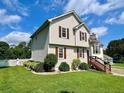 Two-story home featuring vinyl siding, a well-manicured lawn and mature landscaping for added privacy at 19 Magnolia Ne Ct, Rydal, GA 30171