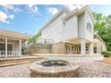 The patio features a brick fire pit and stone retaining wall perfect for outdoor entertaining at 2555 Chattahoochee Ln, Cumming, GA 30041