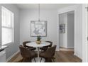 Cozy dining space with a round table, four chairs, and bright natural light from a large window at 4457 Watson Ridge Dr, Stone Mountain, GA 30083