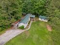 Aerial shot of a home with green metal roof, surrounded by lush trees and expansive yard at 4934 Pickys Se Holw, Acworth, GA 30102