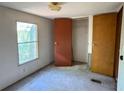 This bedroom features a large window, standard closet, carpet and neutral paint at 4934 Pickys Se Holw, Acworth, GA 30102