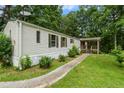 Charming single-story home with lush landscaping and a cozy front porch, offering a welcoming curb appeal at 4934 Pickys Se Holw, Acworth, GA 30102
