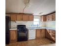 The kitchen has wooden cabinets, standard appliances, and tile flooring at 4934 Pickys Se Holw, Acworth, GA 30102