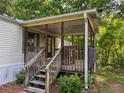 Covered porch featuring a classic wooden railing and steps leading to a house at 4934 Pickys Se Holw, Acworth, GA 30102