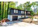 Captivating home exterior featuring a garage and a well-kept lawn at 809 Vinton Wood Rd, Forest Park, GA 30297
