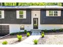 Charming home entrance with black door and manicured landscape at 809 Vinton Wood Rd, Forest Park, GA 30297