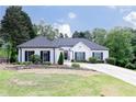 Charming single-story home featuring a beautifully maintained lawn and long driveway at 823 Laurel Crest Sw Ct, Marietta, GA 30064