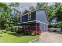 Picture of the house showcasing its quaint design, porch, and spacious yard, perfect for outdoor enjoyment at 233 Clayton St, Fairburn, GA 30213