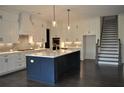 Modern kitchen features white cabinets, center island and stainless steel appliances at 333 Mont Harmony Sw Rd, Powder Springs, GA 30127