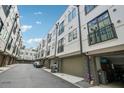 Townhome exterior with garage access and small balcony, featuring a modern design at 71 Krog Ne St, Atlanta, GA 30307