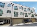 Modern townhome exterior with garage access and small balcony with black trim at 71 Krog Ne St, Atlanta, GA 30307