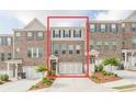 Charming townhome boasts a brick facade, two-car garage, and inviting curb appeal at 123 Matson Sw Run, Mableton, GA 30126