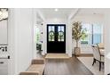 Bright foyer with dark wood floors, a decorative rug, and charming wreath-adorned double doors at 2381 Jones Phillips Rd, Dacula, GA 30019