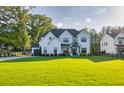 Beautiful two-story home with a well-manicured lawn, black trim windows, and a welcoming driveway at 2381 Jones Phillips Rd, Dacula, GA 30019