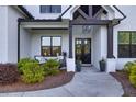 Inviting porch with stylish seating and decorative plants flanking the double-door entrance at 2381 Jones Phillips Rd, Dacula, GA 30019