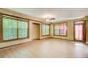 Versatile bonus room featuring neutral walls, wood-look floors, and natural light from the large windows at 245 Ashley Forest Dr, Fayetteville, GA 30214
