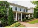 Two-story home with landscaped yard and inviting front porch featuring white columns and a vibrant red front door at 775 A Harrison Se Pl, Atlanta, GA 30315
