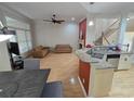 Open living space with hardwood floors, a fireplace, and a kitchen island with granite countertops, ideal for modern living at 1042 Emory Parc Pl, Decatur, GA 30033