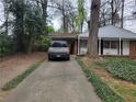 View of the house from the driveway featuring a convenient carport at 2137 Plantation Ln, Chamblee, GA 30341