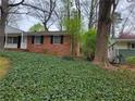 Brick home with lovely green ground cover and mature trees at 2137 Plantation Ln, Chamblee, GA 30341