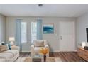 Virtually staged living room featuring new wood flooring and bathed in natural light at 2347 Fairway Sw Cir, Atlanta, GA 30331