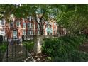 Apartment building exterior with lush trees, wrought iron fencing and a courtyard patio with outdoor seating at 2840 Peachtree Nw Rd # 307, Atlanta, GA 30305