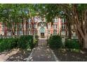 Elegant brick apartment building with well-manicured landscaping and a welcoming walkway leading to the entrance at 2840 Peachtree Nw Rd # 307, Atlanta, GA 30305