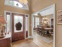 Inviting foyer with hardwood floors, a decorative front door, and views into dining room at 1466 Lake Forest Ln, Mcdonough, GA 30253