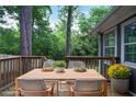 Inviting wooden deck perfect for outdoor dining and entertaining amidst a lush, wooded backdrop at 4448 Denise Dr, Decatur, GA 30035