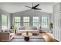Bright living room featuring a comfortable sofa, stylish rug, and large windows for natural light at 4448 Denise Dr, Decatur, GA 30035