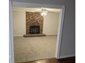 Cozy living room features a brick fireplace, neutral carpeting, and a ceiling fan, creating a relaxing atmosphere at 4448 Denise Dr, Decatur, GA 30035