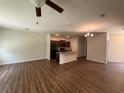 Spacious living room with hardwood floors, kitchen and a dining area at 6474 Grey Fox Way, Riverdale, GA 30296