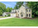 Charming two-story home with a two-car garage, well-manicured lawn, and mature trees at 6895 Old Fox Trl, Stone Mountain, GA 30087