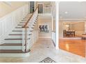 Inviting foyer featuring tile flooring, staircase, and open view to dining area at 6895 Old Fox Trl, Stone Mountain, GA 30087