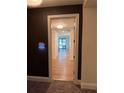Elegant hallway with hardwood floors and white trim, leading to living area at 867 Peachtree Ne St # 202, Atlanta, GA 30308