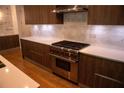Modern kitchen with stainless steel range, white countertops and marble backsplash at 867 Peachtree Ne St # 202, Atlanta, GA 30308