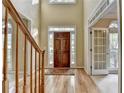 Inviting foyer with hardwood floors, staircase, and a solid wood front door with sidelights, offering a warm welcome at 1885 Milfield Cir, Snellville, GA 30078
