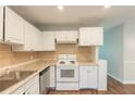 Functional kitchen featuring white cabinets, stainless steel appliances, and a stylish backsplash at 2499 Shiloh Dr, Decatur, GA 30034