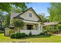 Craftsman style home with a well-manicured lawn and brick-lined walkway surrounded by greenery at 622 Seminole Ne Ave, Atlanta, GA 30307