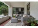 Cozy front porch setup with cushioned seating, textured rug, and serene outdoor views at 622 Seminole Ne Ave, Atlanta, GA 30307