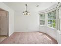 A bright dining room with a bay window and a decorative chandelier at 742 Redland Dr, Jonesboro, GA 30238