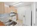 This is an alternate view of the bright kitchen featuring light wood cabinets and white appliances at 742 Redland Dr, Jonesboro, GA 30238