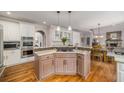 Open concept kitchen with granite countertops, stainless steel appliances, and a breakfast bar at 2425 Hamptons Psge, Alpharetta, GA 30005
