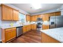 Well-equipped kitchen with stainless steel appliances, granite countertops, and wooden cabinets at 2715 Haynes Club Circle, Grayson, GA 30017