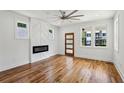 Spacious living room with hardwood floors, fireplace accent wall, and ample natural light from large windows at 515 Cohen St, Atlanta, GA 30310