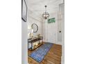 Beautiful foyer with hardwood floors, console table, and elegant lighting fixture at 604 Timm Valley Ne Rd # A, Atlanta, GA 30305